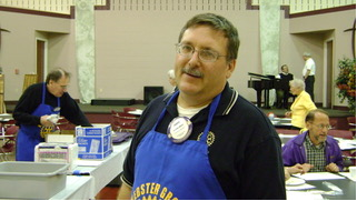 Pancake Day volunteer wearing a Rotary apron in 2009