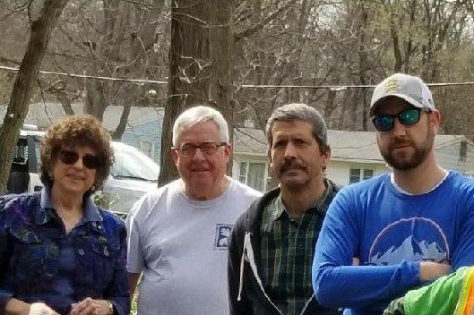 Four Arbor Day participants gathered for a photo outdoors
