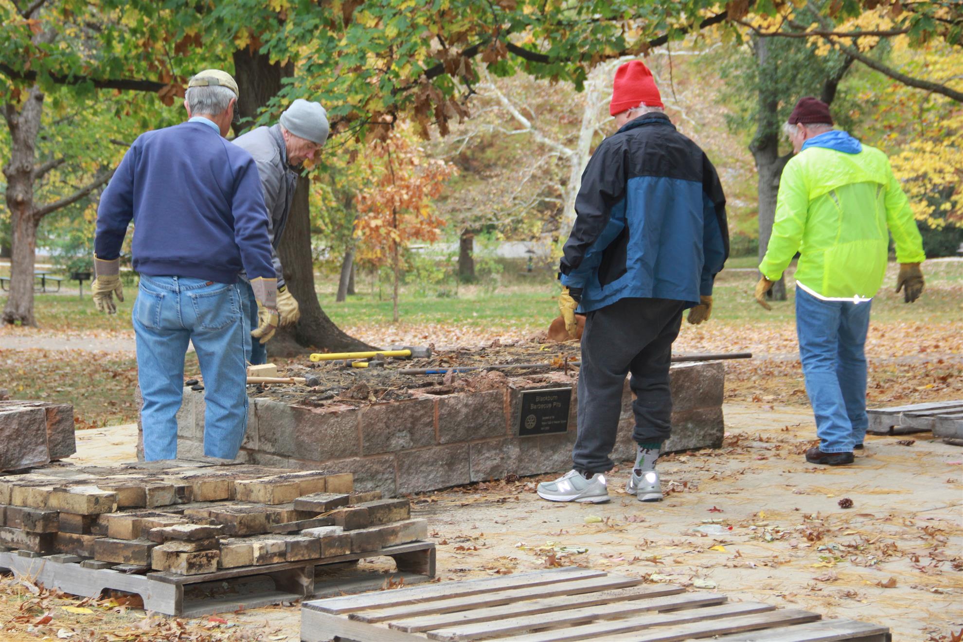 Make a Difference Day volunteers working around a Rotary-marked barbecue pit in Blackburn Park in 2023