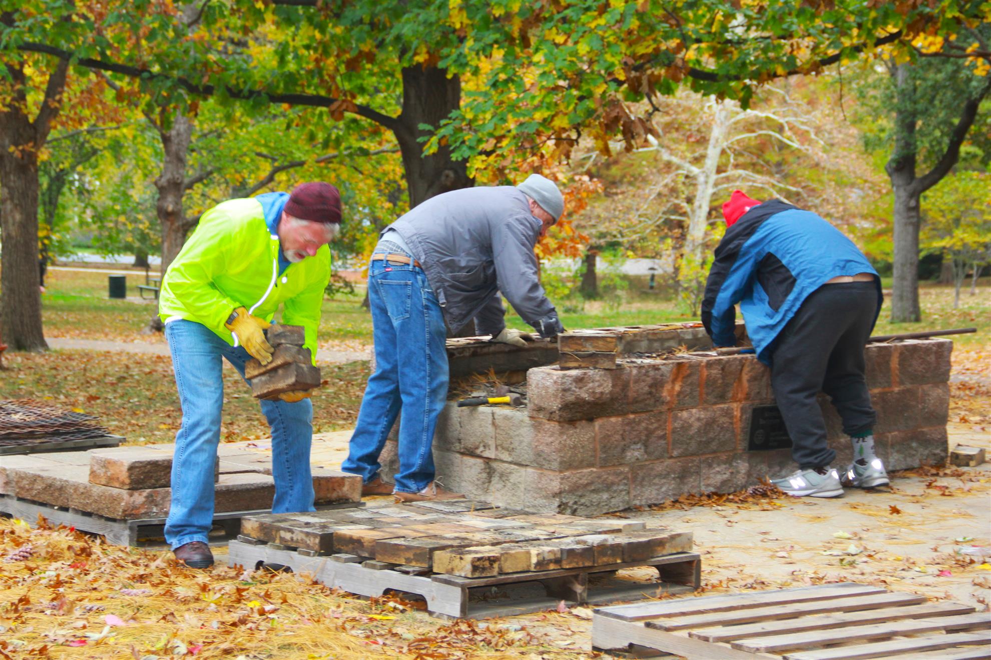 Make a Difference Day volunteers doing masonry work at an outdoor park site in 2023