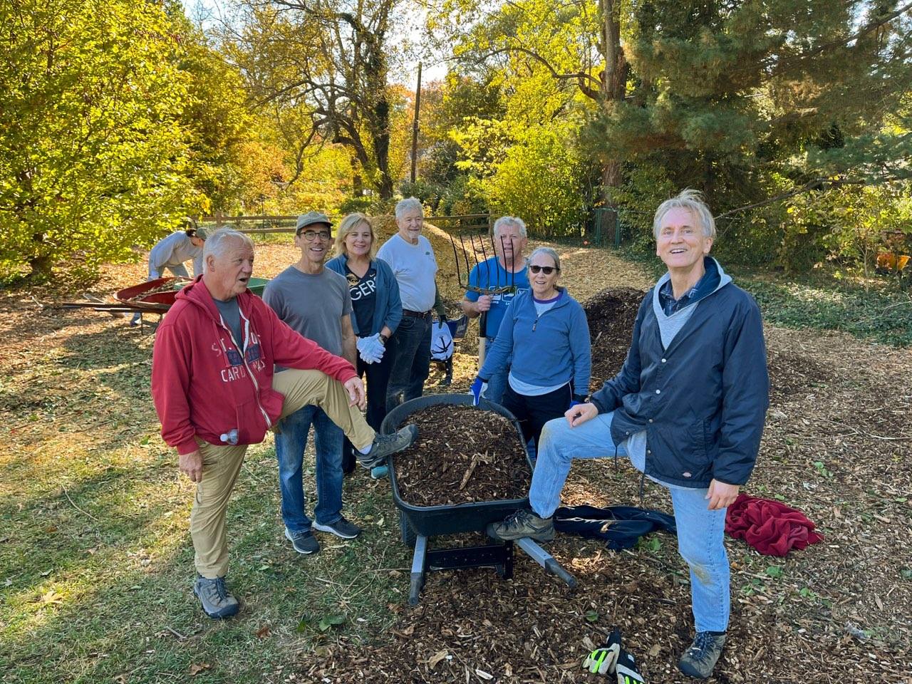 Webster Groves Rotary volunteers beside a wheelbarrow at the Century Oaks Grove
